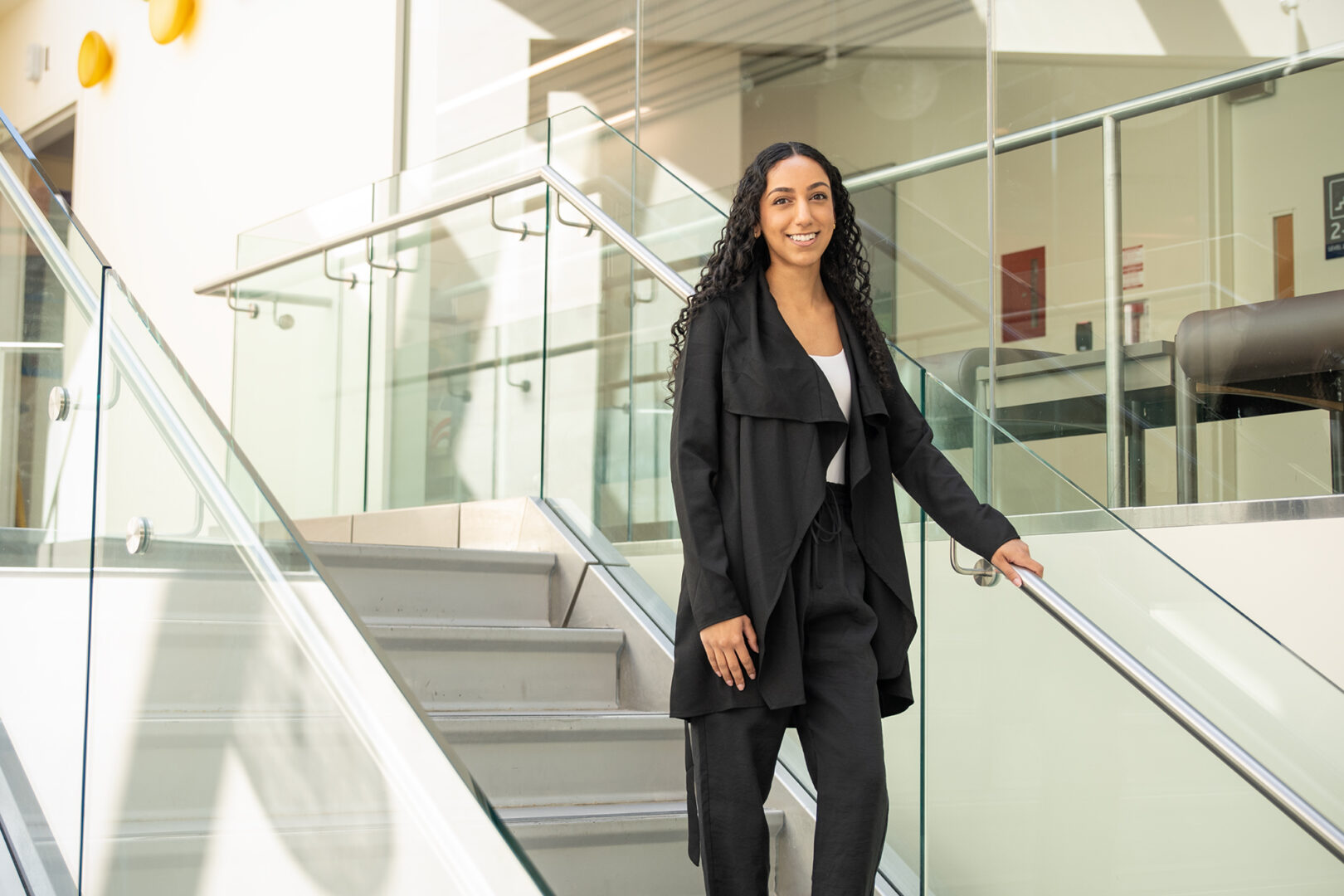 image of Gurleen Singh, an oak valley health staff member at markham stouffville hospital posing at the stairs nearby the lower link lobby